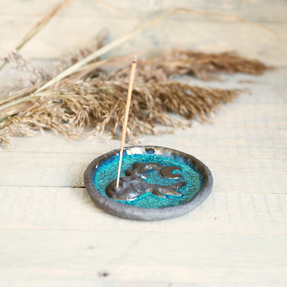 Handmade ceramic incense holder featuring mystic creature and the moon design. Crafted from black grogged clay and covered with blue glaze.