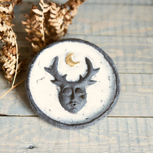 Handmade ceramic incense holder featuring mystic creature and gold plated moon design. Crafted from black grogged clay and covered with white glaze.