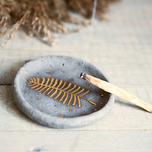 Handmade ceramic incense holder featuring gold plated leaf design. Crafted from gray grogged clay.