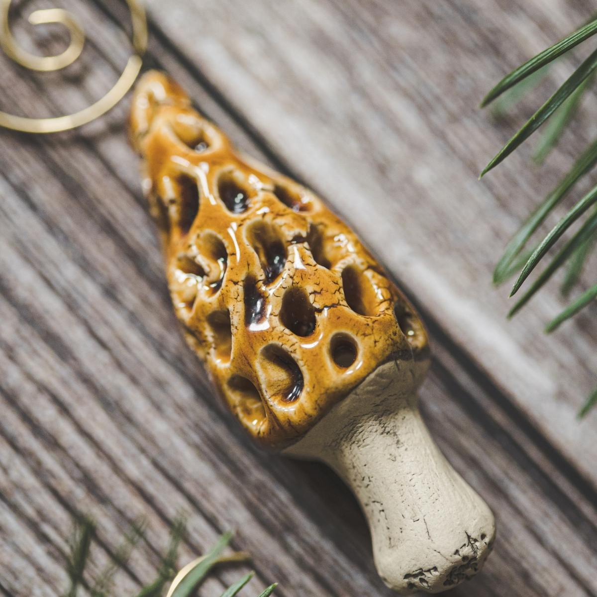 Ceramic False Morel mushroom with glossy brown cap and cream-colored stem. Handmade Christmas tree ornament with hook.