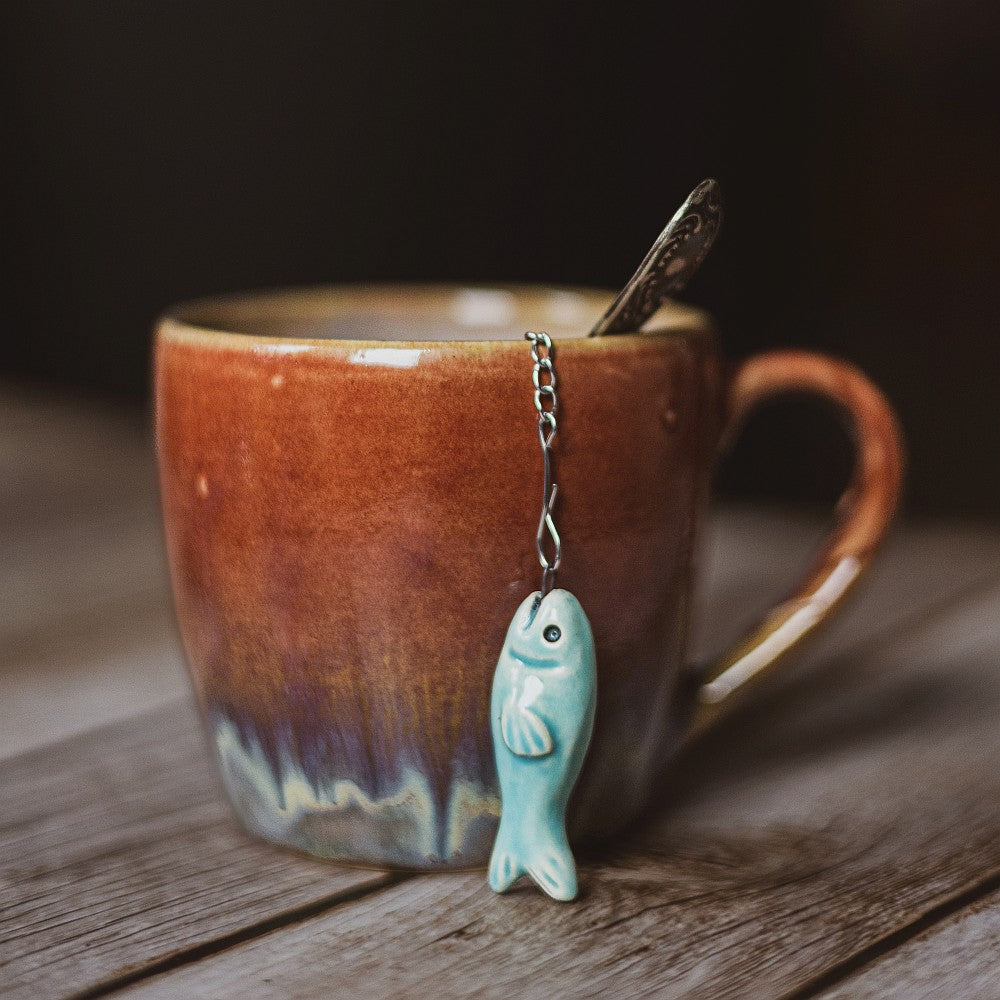 tea infuser with ceramic blue fish hanging from the chain