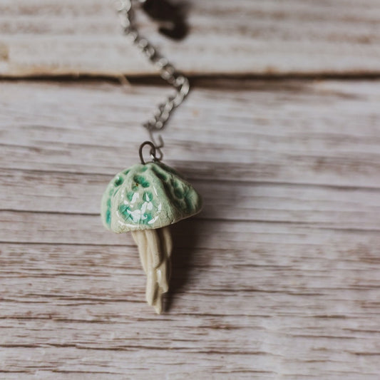 tea infuser with ceramic blue jellyfish hanging from the chain