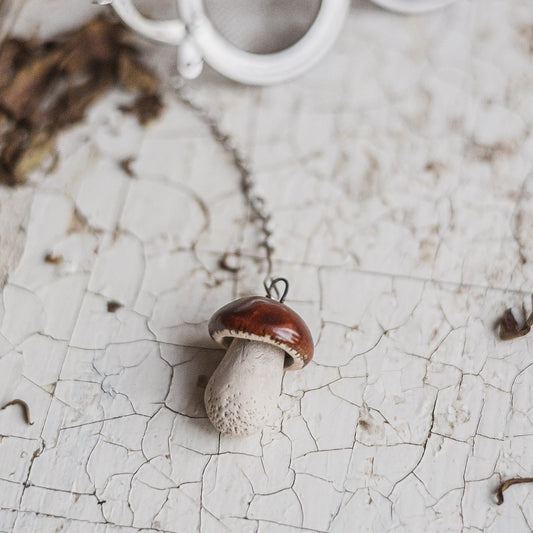 tea infuser with ceramic boletus mushroom hanging from the chain
