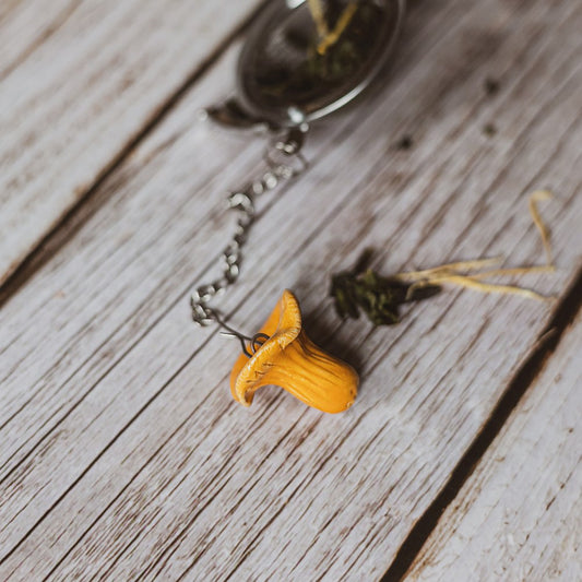 tea infuser with ceramic chanterelle mushroom hanging from the chain
