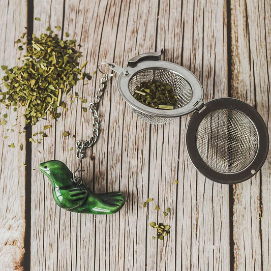 Tea infuser with ceramic green bird hanging from the chain.