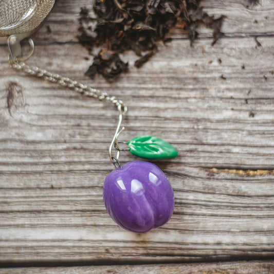 tea infuser with ceramic blue plum hanging from the chain