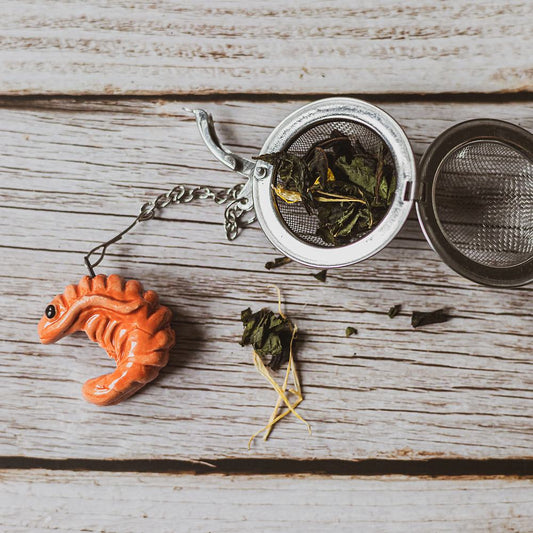 tea infuser with ceramic red shrimp hanging from the chain