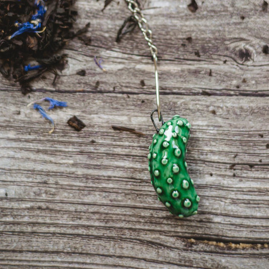 tea infuser with ceramic cucumber hanging from the chain