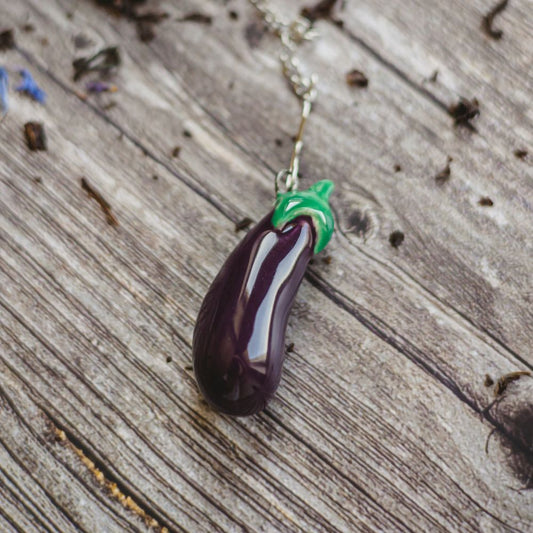 tea infuser with ceramic purple eggplant hanging from the chain