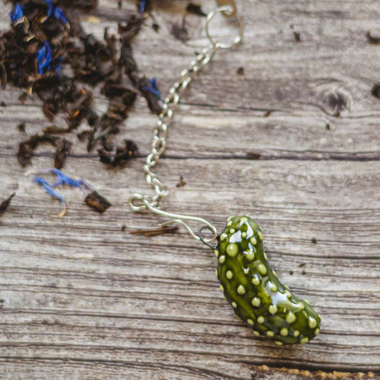 tea infuser with ceramic pickle hanging from the chain