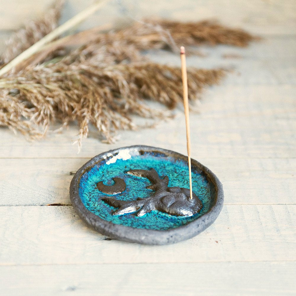Handmade ceramic incense holder featuring mystic creature and the moon design. Crafted from black grogged clay and covered with blue glaze.