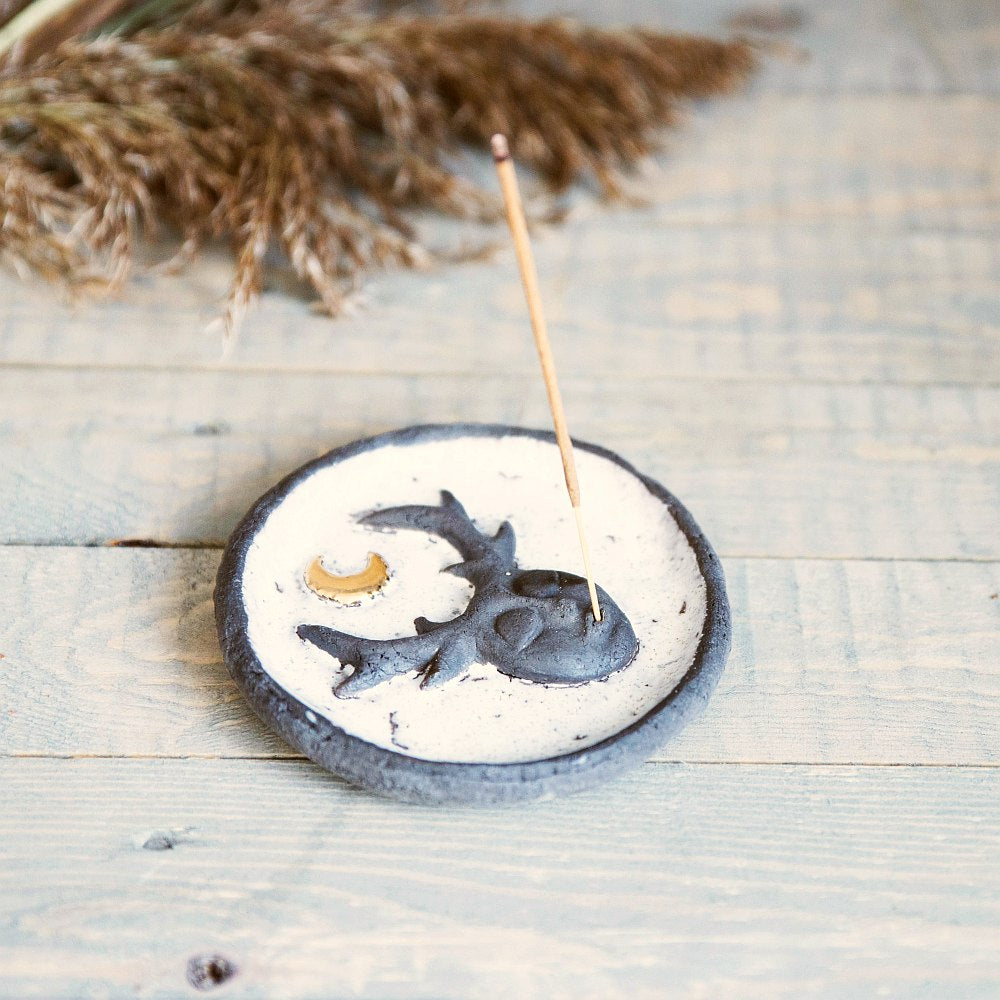 Handmade ceramic incense holder featuring mystic creature and gold plated moon design. Crafted from black grogged clay and covered with white glaze.