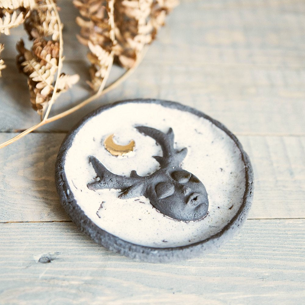 Handmade ceramic incense holder featuring mystic creature and gold plated moon design. Crafted from black grogged clay and covered with white glaze.