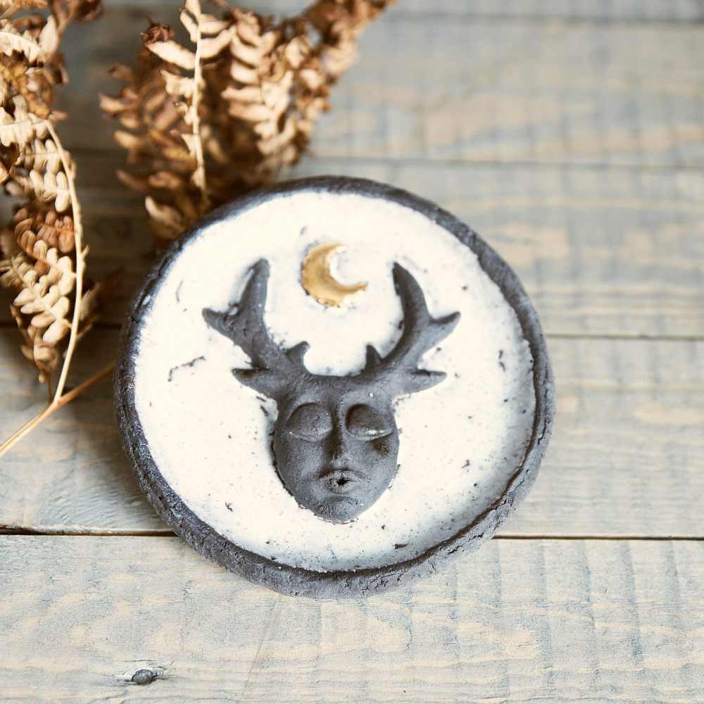 Handmade ceramic incense holder featuring mystic creature and gold plated moon design. Crafted from black grogged clay and covered with white glaze.