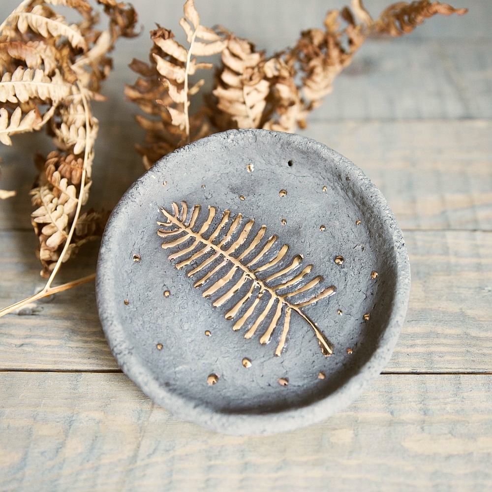 Handmade ceramic incense holder featuring gold plated leaf design. Crafted from gray grogged clay.