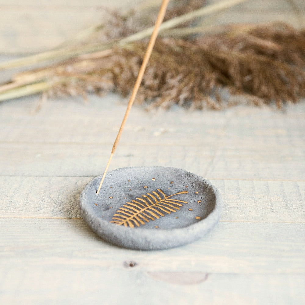 Handmade ceramic incense holder featuring gold plated leaf design. Crafted from gray grogged clay.