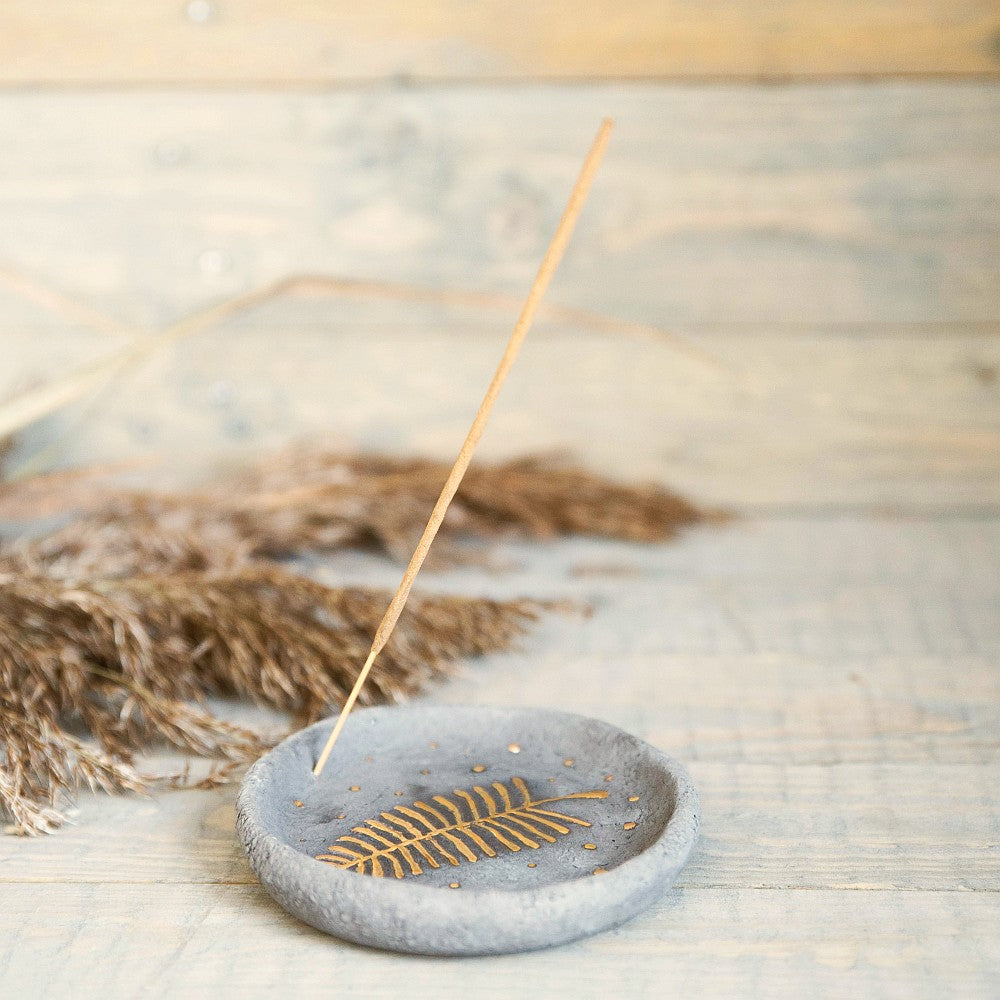 Handmade ceramic incense holder featuring gold plated leaf design. Crafted from gray grogged clay.