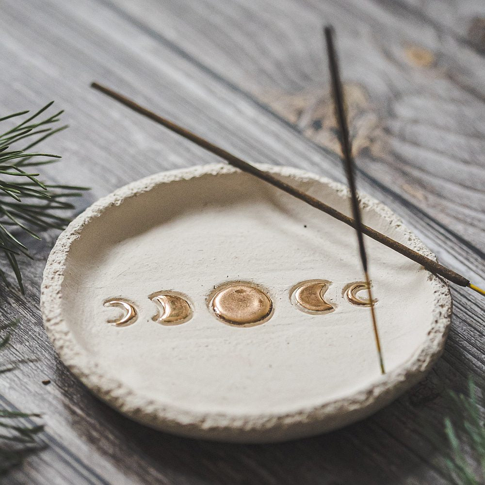Handmade ceramic incense holder featuring gold plated moon phases design. Crafted from ivory grogged clay.