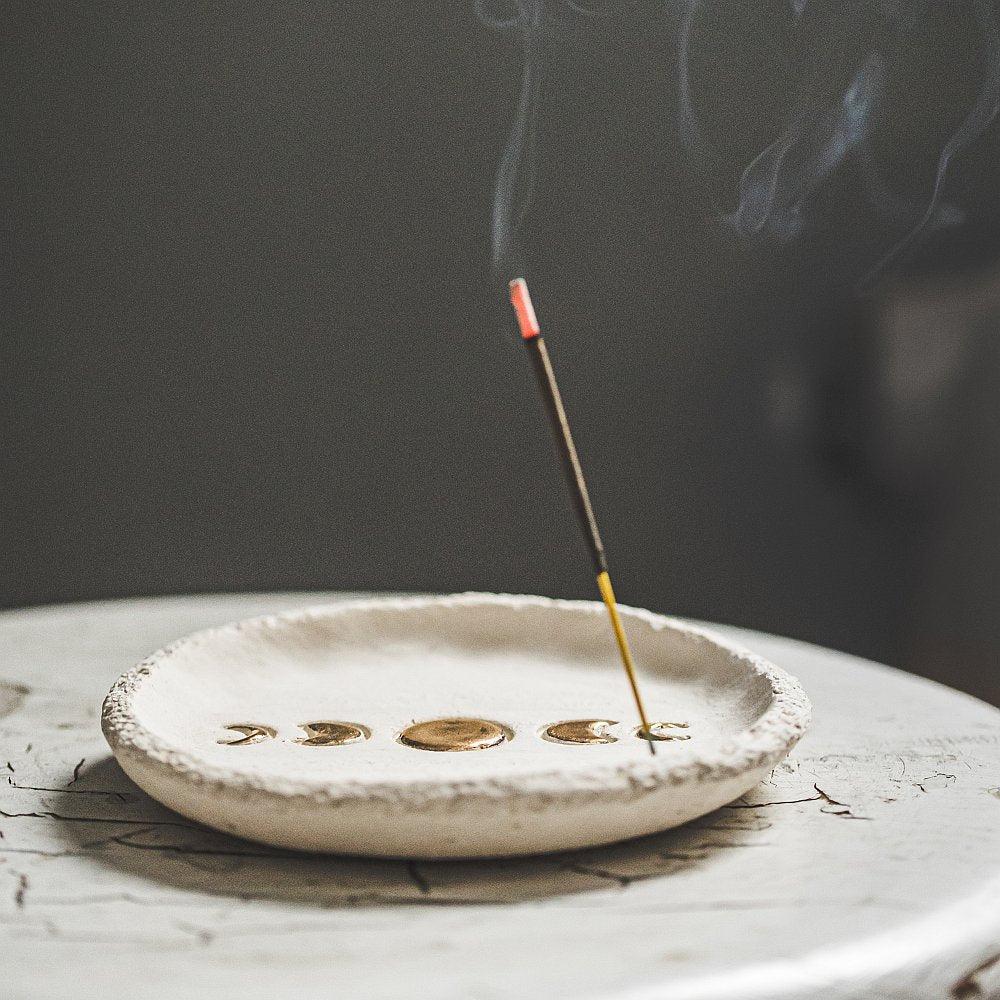 Handmade ceramic incense holder featuring gold plated moon phases design. Crafted from ivory grogged clay.