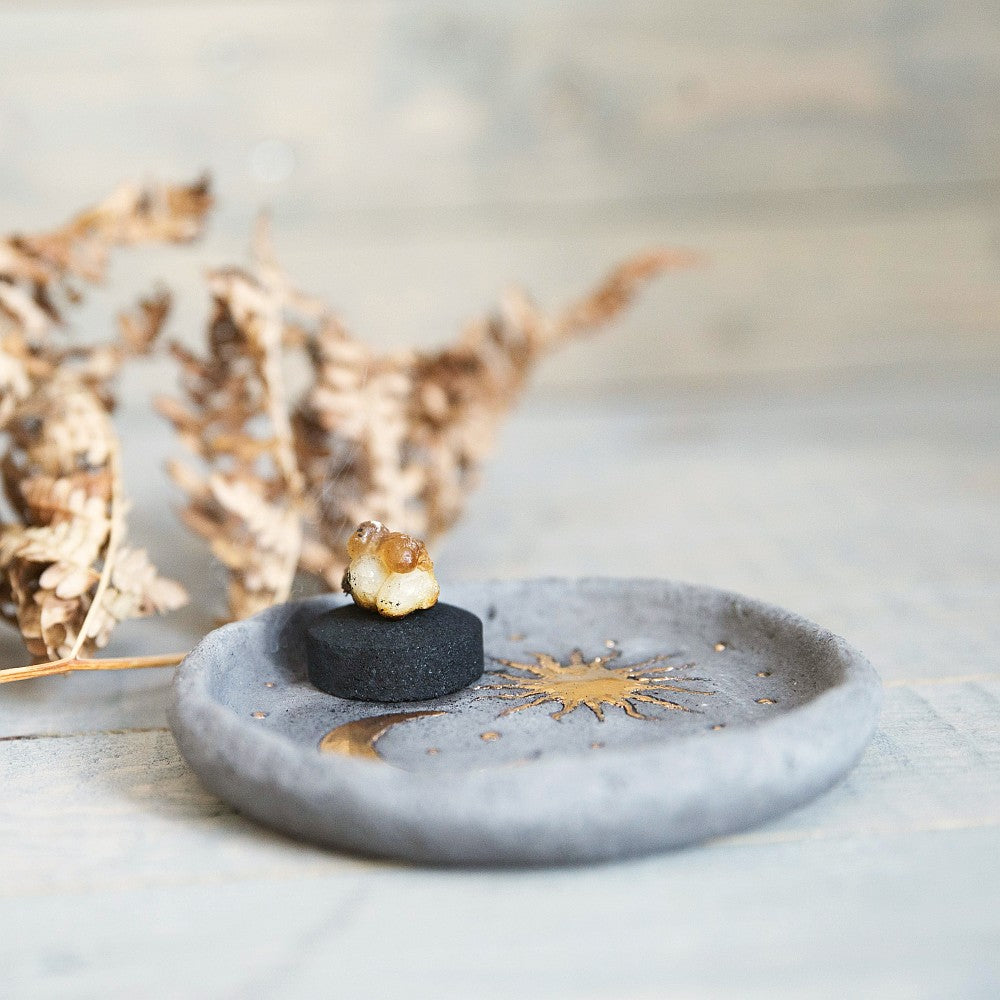 Handmade ceramic incense holder featuring gold plated moon and sun. Crafted from black grogged clay.
