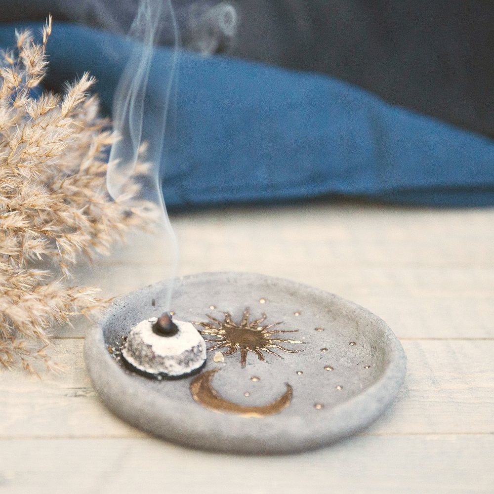 Handmade ceramic incense holder featuring gold plated moon and sun. Crafted from black grogged clay.