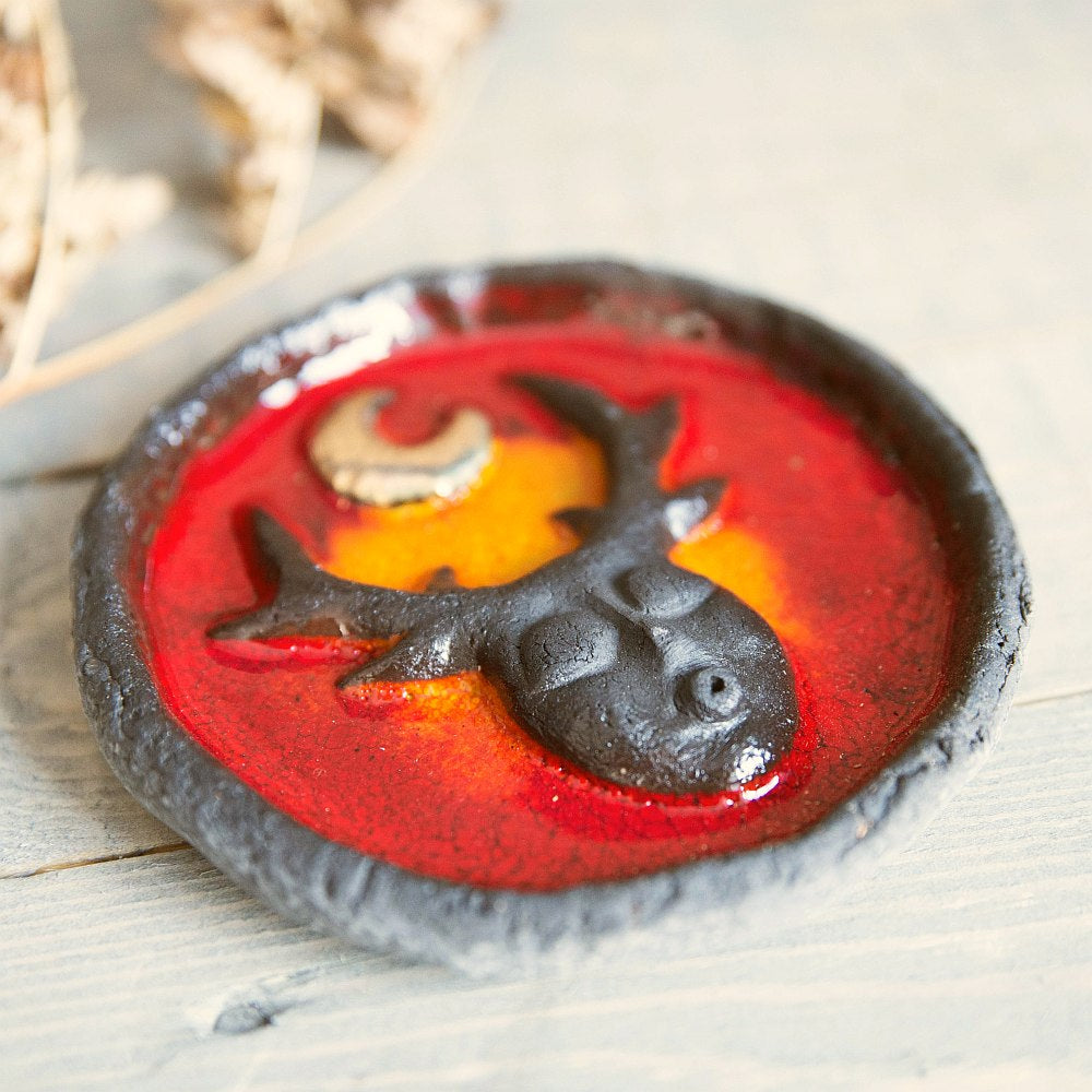 Handmade ceramic incense holder featuring mystic creature and gold plated moon design. Crafted from black grogged clay and covered with red glaze.