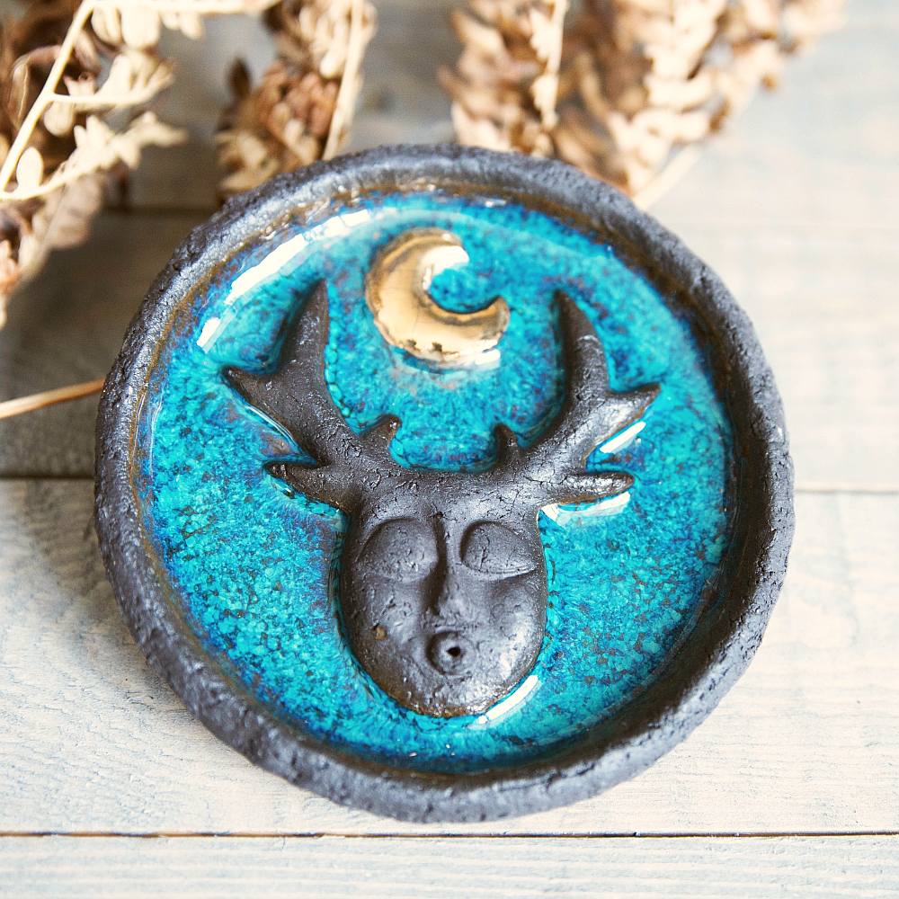Handmade ceramic incense holder featuring mystic creature and gold plated moon design. Crafted from black grogged clay and covered with blue glaze.