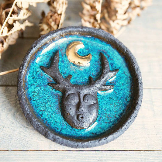 Handmade ceramic incense holder featuring mystic creature and gold plated moon design. Crafted from black grogged clay and covered with blue glaze.