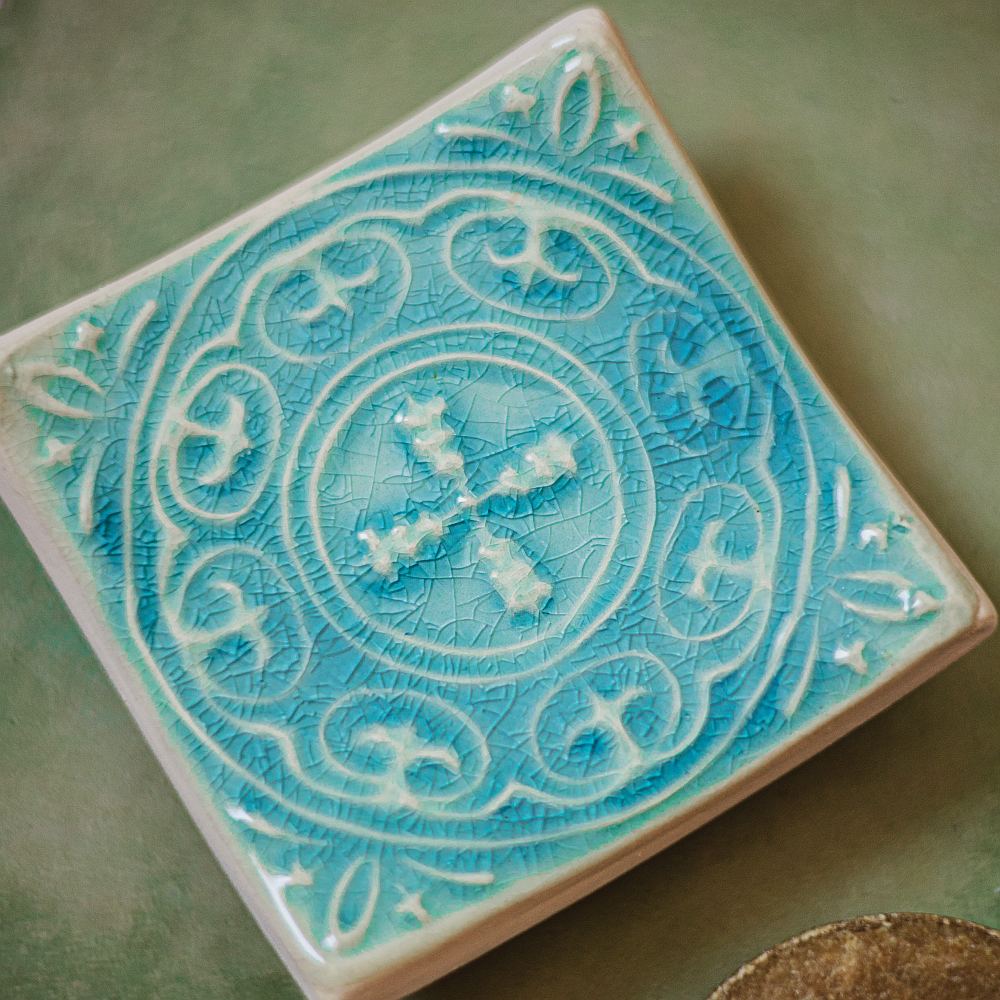 Handmade ceramic square soap dish. Crafted from white clay and finished with a glossy blue glaze. Designed with drainage holes, a concave shape, and four little feet.
