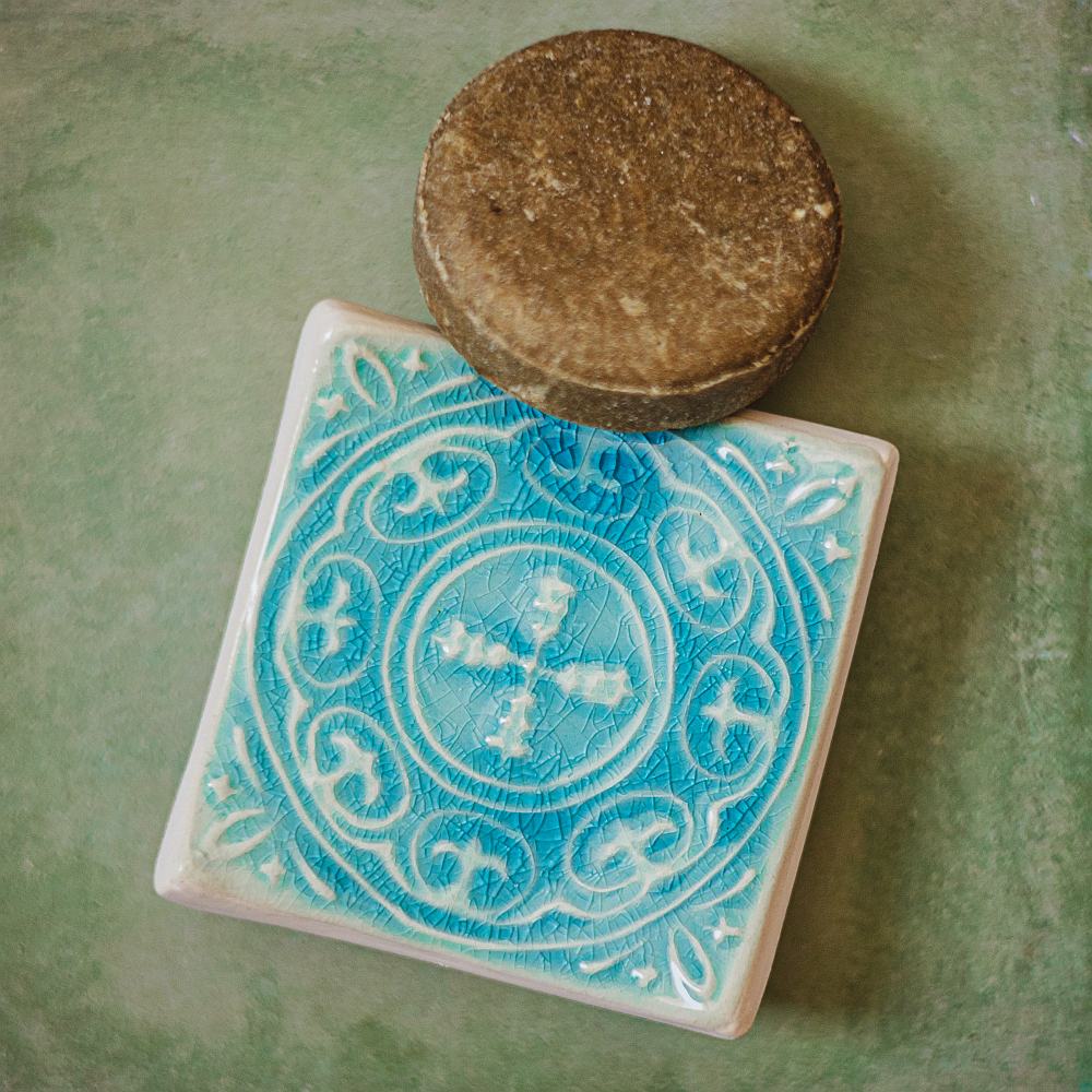 Handmade ceramic square soap dish. Crafted from white clay and finished with a glossy blue glaze. Designed with drainage holes, a concave shape, and four little feet.