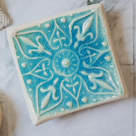 Handmade ceramic square soap dish. Crafted from white clay and finished with a glossy blue glaze. Designed with drainage holes, a concave shape, and four little feet.