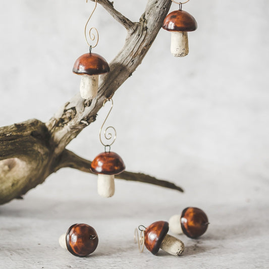 Christmas ornament set of six boletus mushrooms. Hanging on a Christmas tree.