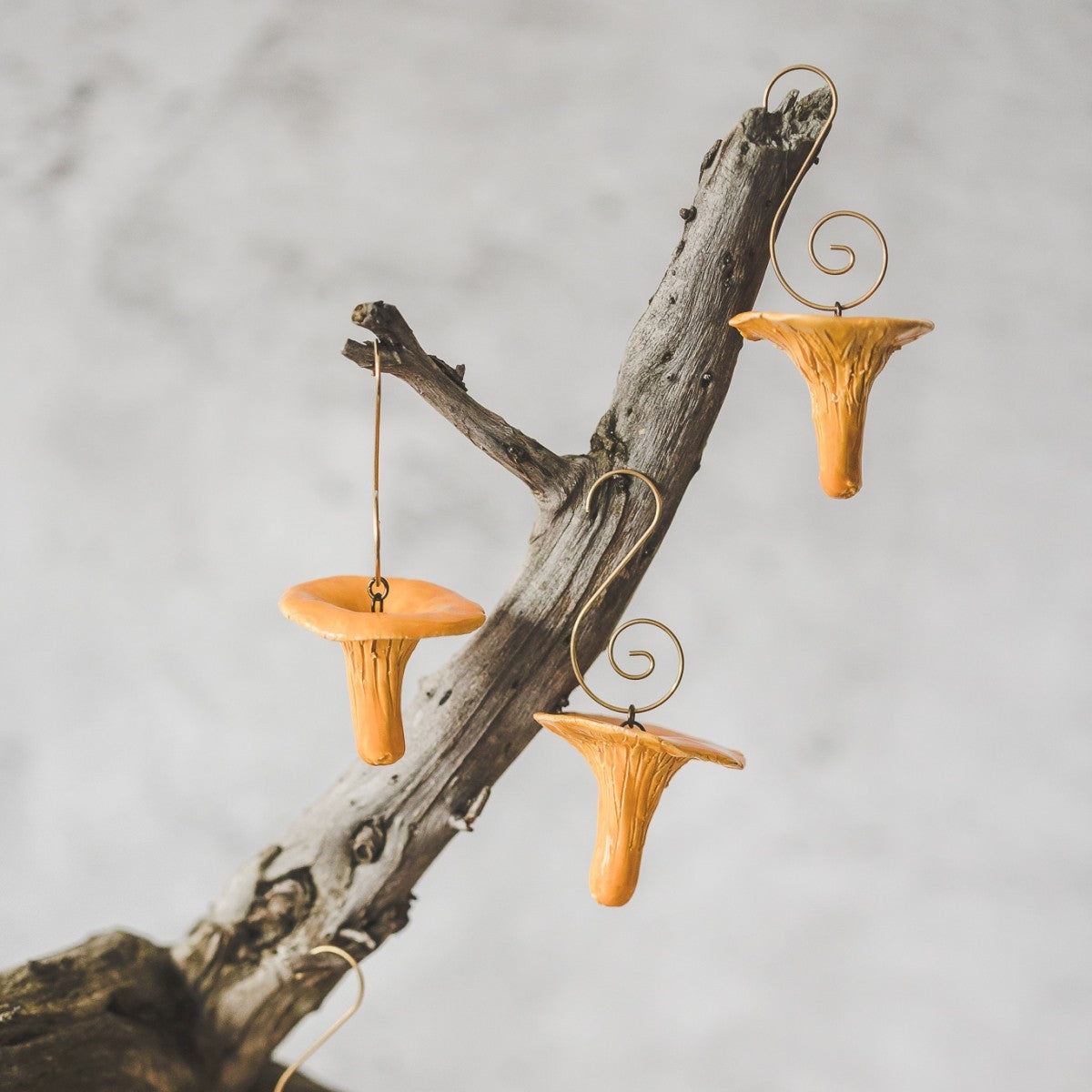 Christmas ornaments ceramic chanterelle mushrooms. Hanging on a Christmas tree.