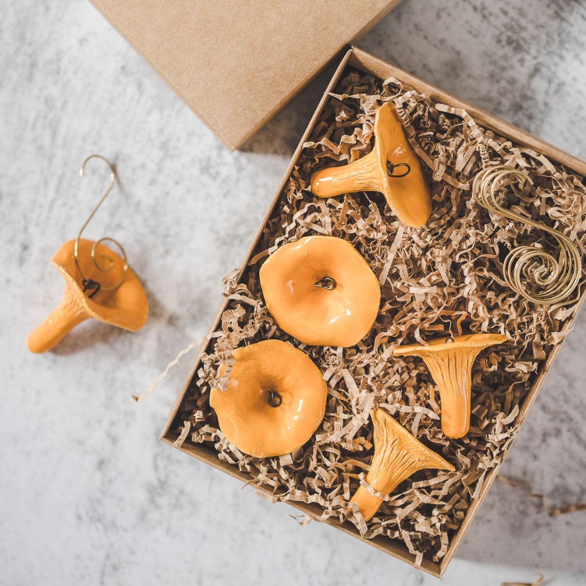 Christmas ornament set of six chanterelle mushrooms. Packed with hooks in a paper gift box.