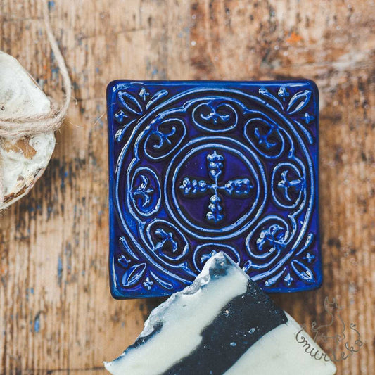 Handmade ceramic square soap dish. Crafted from white clay and finished with a glossy dark blue glaze. Designed with drainage holes, a concave shape, and four little feet.