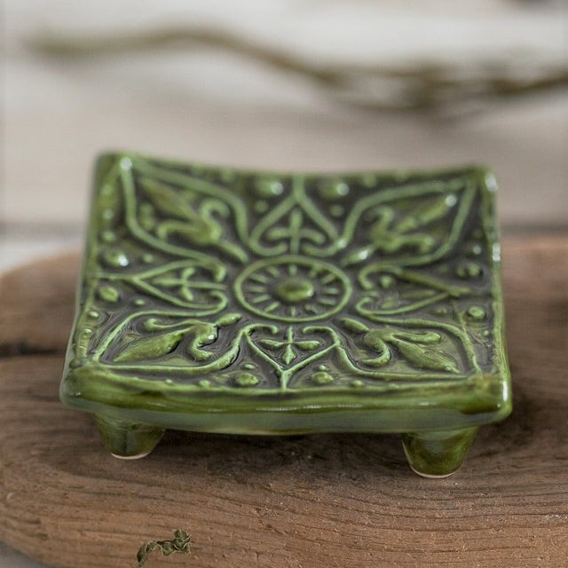 Handmade ceramic square soap dish. Crafted from white clay and finished with a glossy moss green glaze. Designed with drainage holes, a concave shape, and four little feet.