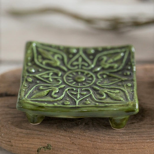 Handmade ceramic square soap dish. Crafted from white clay and finished with a glossy moss green glaze. Designed with drainage holes, a concave shape, and four little feet.