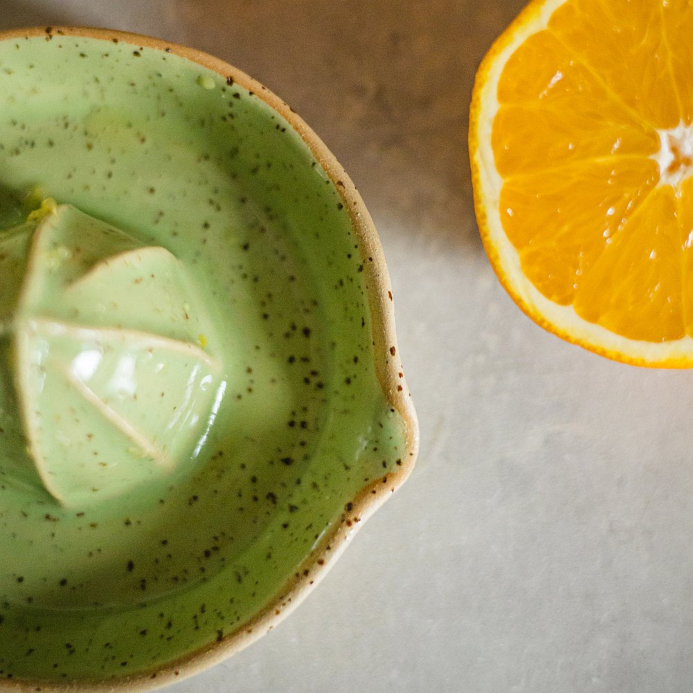 citrus juicer made of yellow dotted clay and covered with greenish glaze