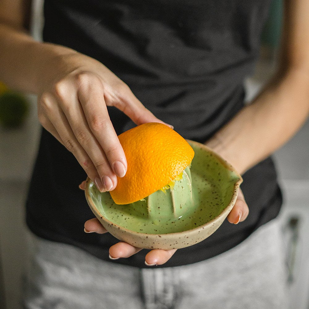 citrus juicer made of yellow dotted clay and covered with greenish glaze