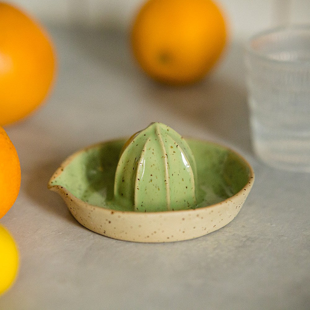 citrus juicer made of yellow dotted clay and covered with greenish glaze