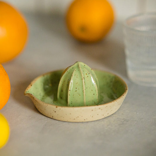 citrus juicer made of yellow dotted clay and covered with greenish glaze
