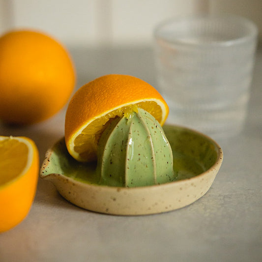 citrus juicer made of yellow dotted clay and covered with greenish glaze