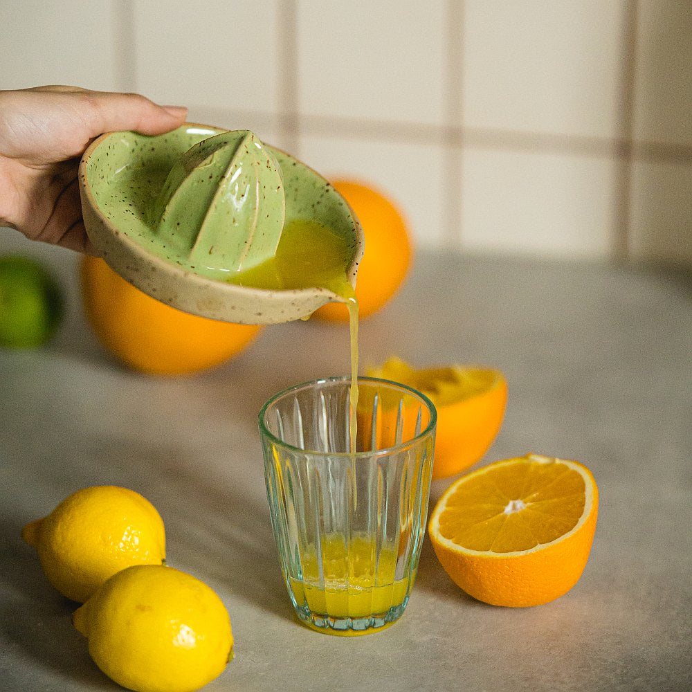 citrus juicer made of yellow dotted clay and covered with greenish glaze