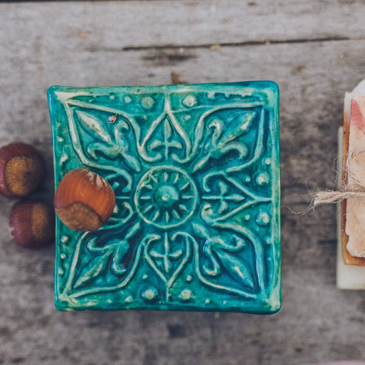 Handmade ceramic square soap dish. Crafted from white clay and finished with a glossy blue glaze. Designed with drainage holes, a concave shape, and four little feet.