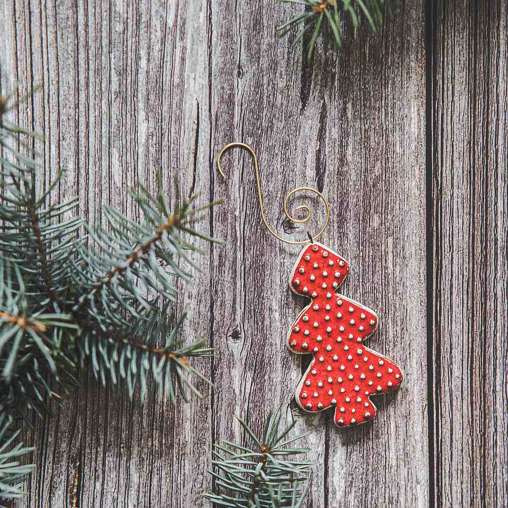 Ceramic red dotted fir Christmas tree ornament with hook.