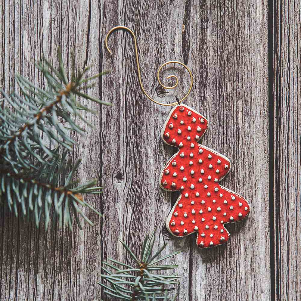 Ceramic red dotted fir Christmas tree ornament with hook.