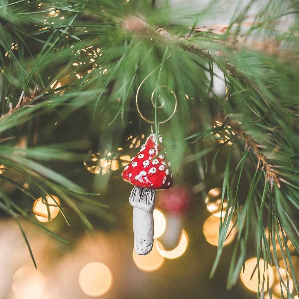 Christmas ornament red amanita mushrooms. Hanging on a Christmas tree.
