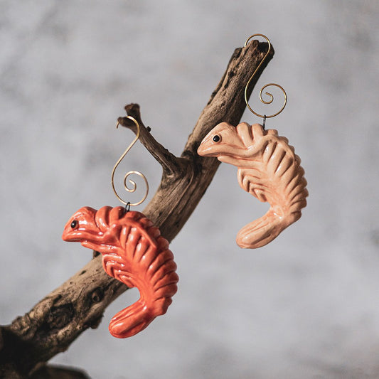 Ceramic red and pink shrimp ornaments with black eyes. The decorations are handmade and comes with yellow hooks.