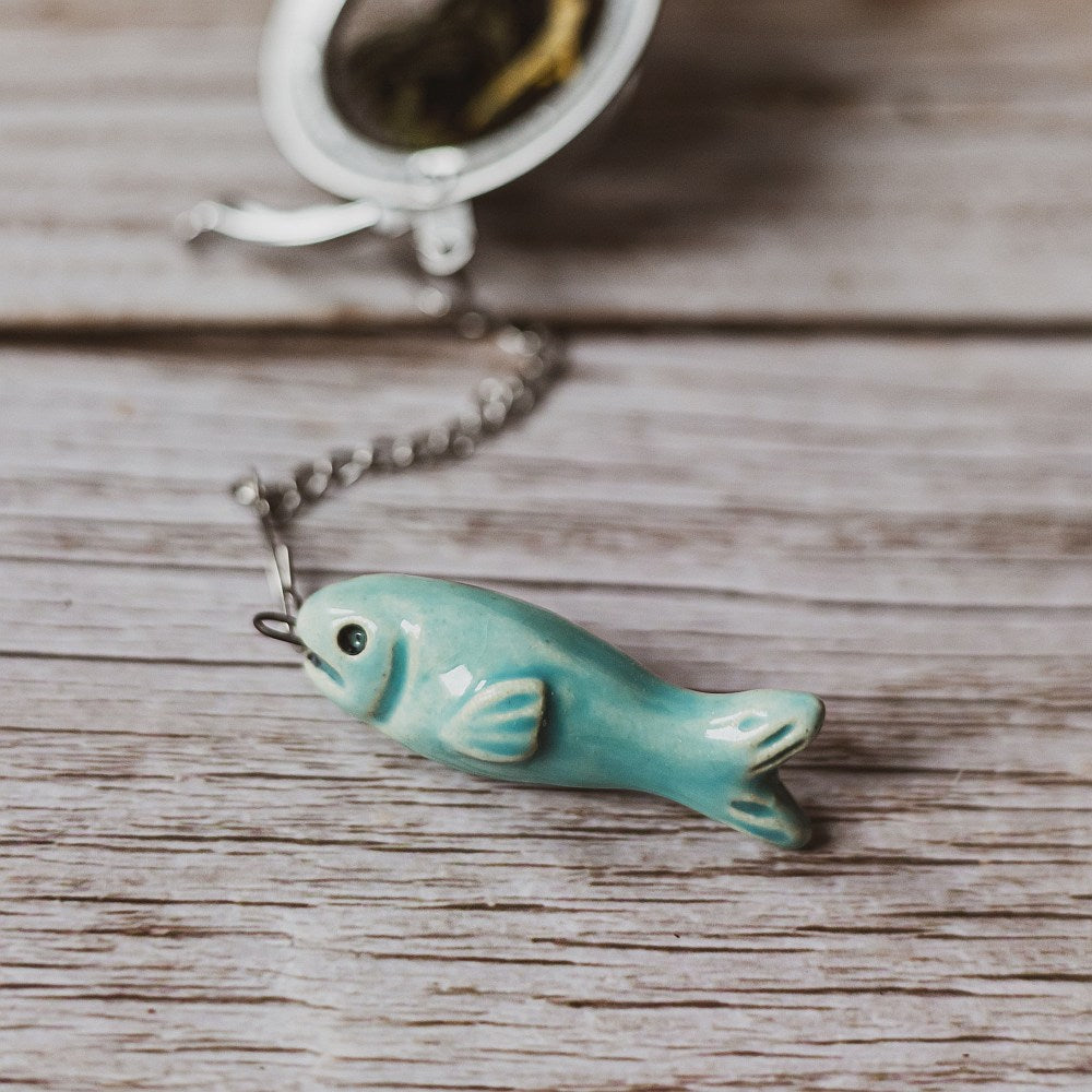 tea infuser with ceramic blue fish hanging from the chain