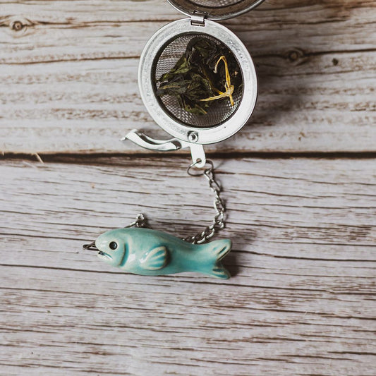 tea infuser with ceramic blue fish hanging from the chain